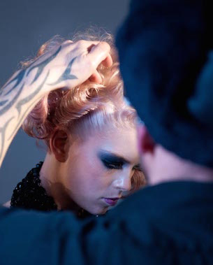 Hairstylist working on model's hair